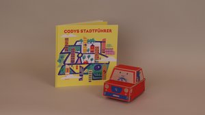 Lernroboter Cody und die Anleitung "Codys Stadtführer"